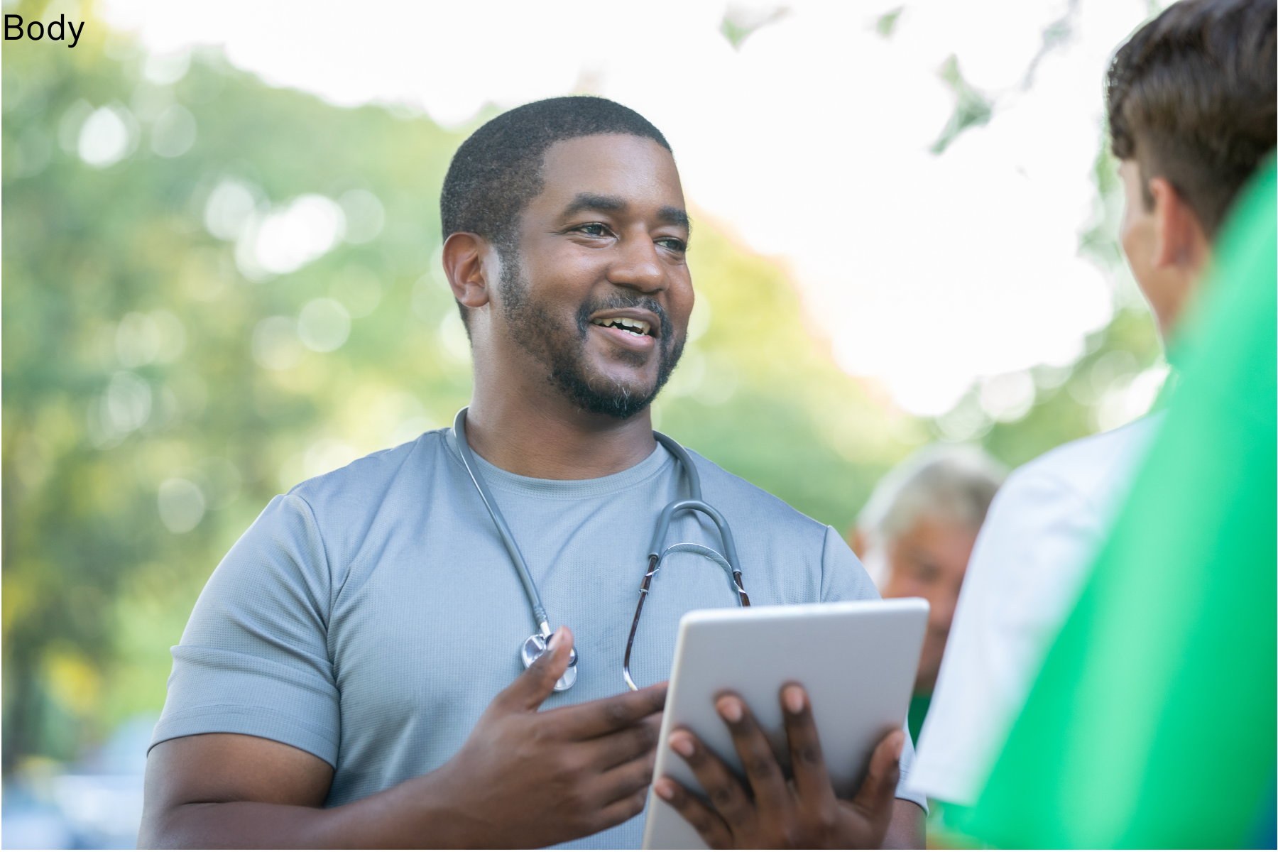 Man smiling with tablet and patient