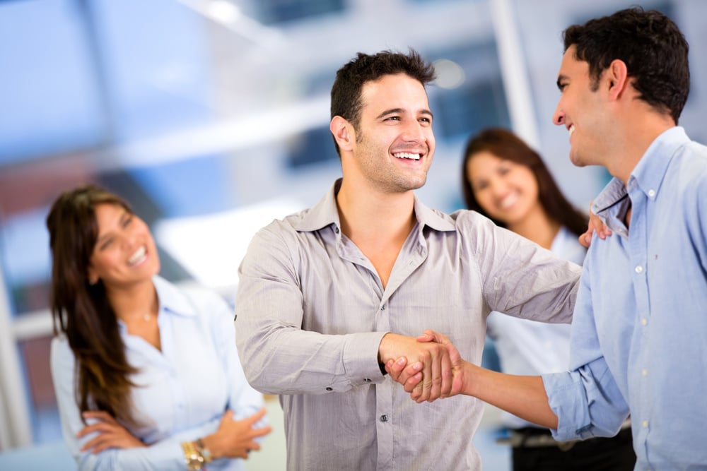 Handshake of two business men closing a deal at the office