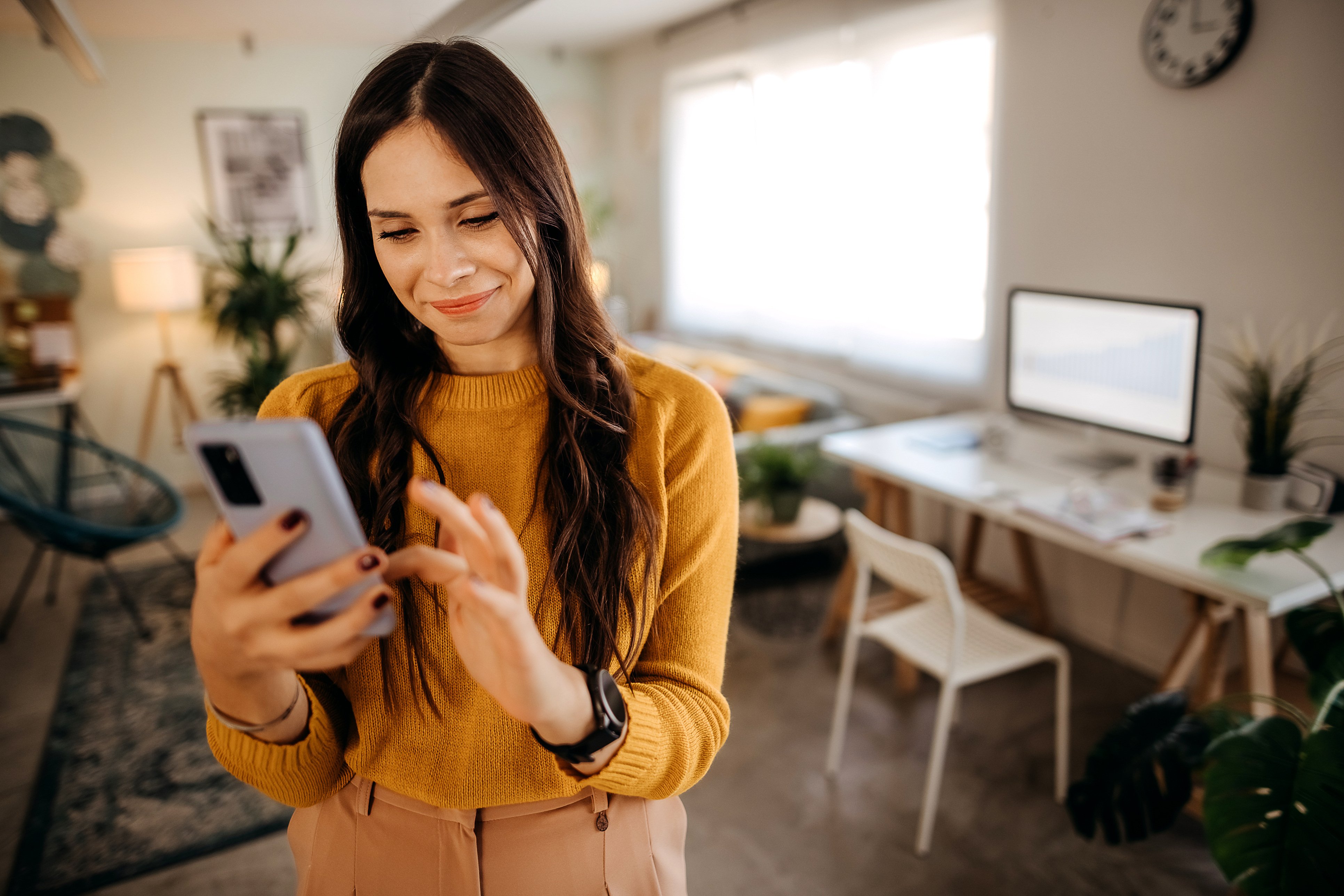 Specialist Care woman smiling at phone