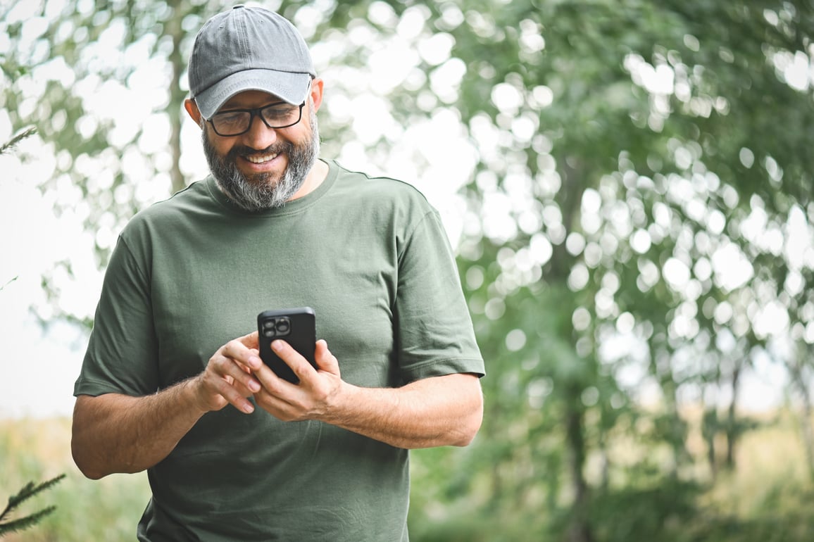 man smiling at phone