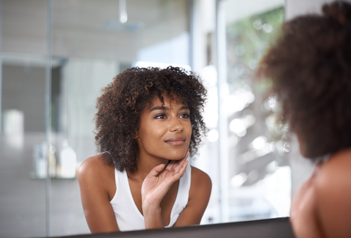 woman looking at herself in a mirror 