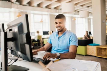 Businessman smiling at computer