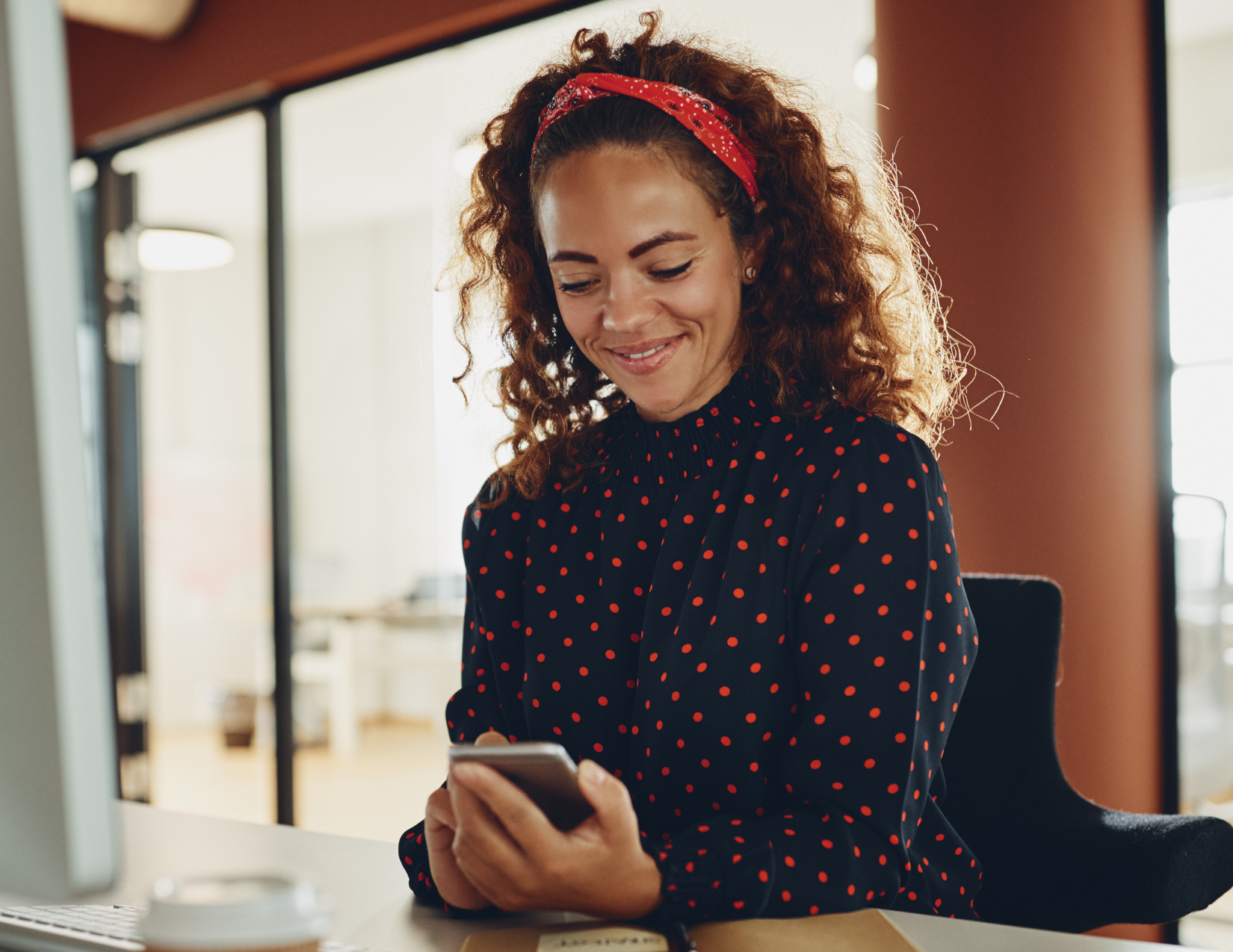 Woman smiling looking at her phone